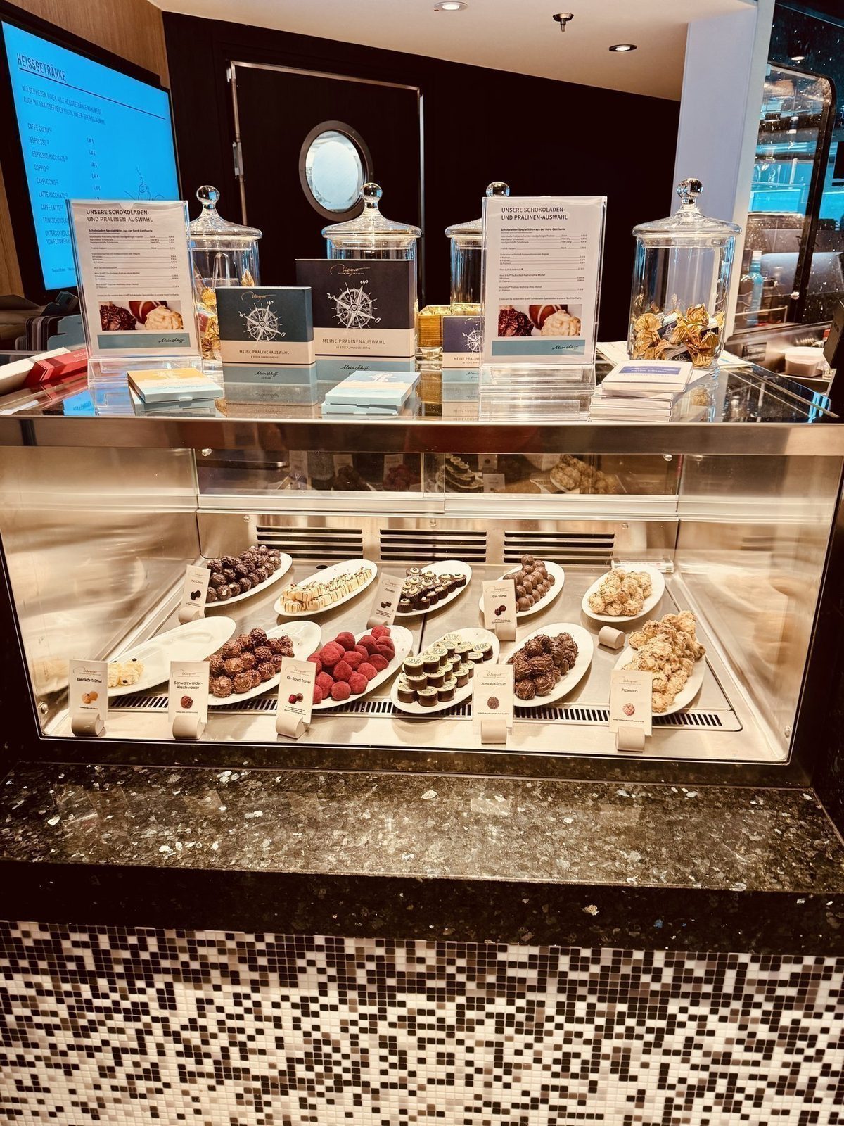 Ein Schokoladenpralinenbuffet wird präsentiert, bestehend aus verschiedenen Pralinenarten auf Tellern